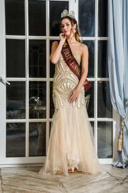 Bej Güzellik esmer modelinde portresi lüks iç pencereye yakın duran elbise 