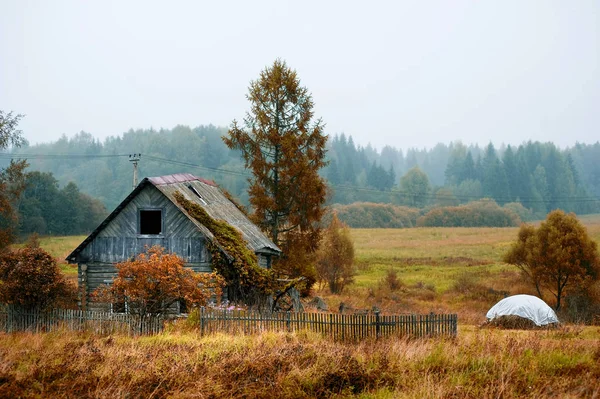 Övergivna skrangliga hus utan fönster med en delvis saknas staket. Kopiera utrymme — Stockfoto