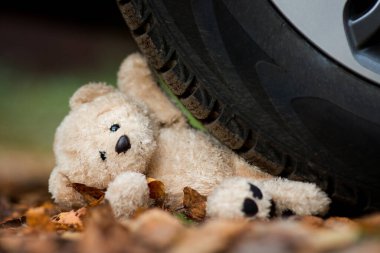 teddy bear crushed by a car wheel clipart