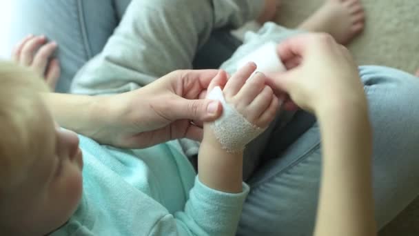 Kobieta Leczy Rękę Małego Dziecka Opatrując Bandażem Zbliżenie Widok Góry — Wideo stockowe
