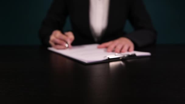 Frau in einem Geschäftsanzug schlägt vor, eine Vereinbarung zu unterzeichnen, die für einen gedruckten Vertrag wirbt — Stockvideo