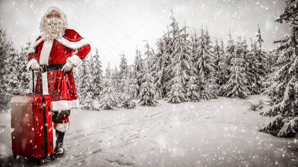 Santa Claus with snowy winter background. Presents transportation on a heavy snowy winter day. Spruce and fir trees covered in snow in distance.