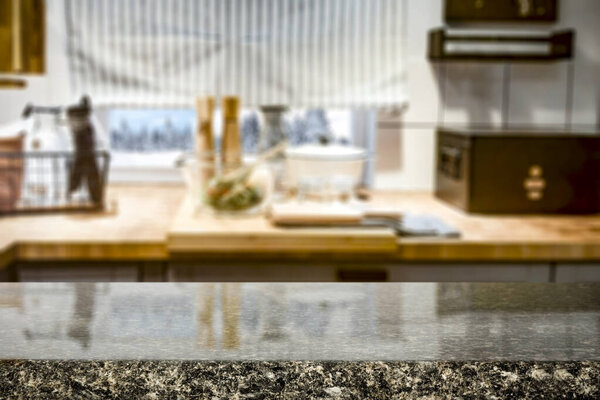 Kitchen table top with empty space for you products or decoration and blurred kitchen furniture background.