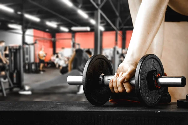 Dumbbell, barbell and workout in the gym. Space for products and decorations or text with blurred gym background.