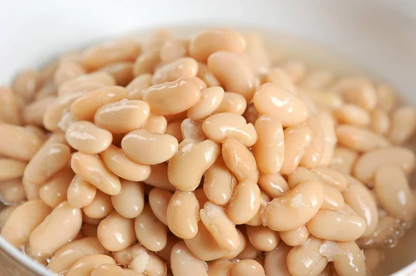 Canned white beans The product occupies the entire frame space. White background. Close-up. Macro shooting.