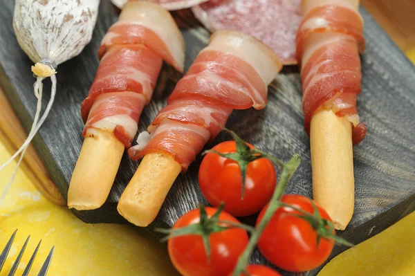 Bacon Bread Sticks Wooden Board Next Slices Salami Cherry Tomato — Stock Photo, Image