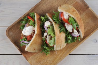 Domates, marul ve sos ile Falafel pide ekmek. Açık ahşap arka plan. Close. Yukarıdan görüntüle.