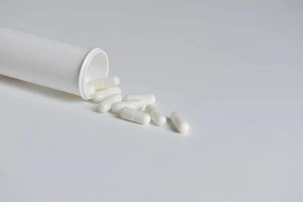 White Capsules Fall Out White Plastic Bottle Tablets Oral Administration — Stock Photo, Image