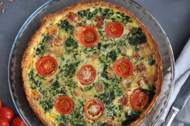 ıspanak ve pastırma ile açık quiche pasta. Gri arka plan. Yukarıdan görüntüleyin. Close. Makro çekimi.