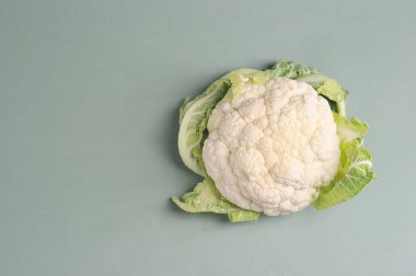 Head of cauliflower on a light background.  View from above.  Free space for text.