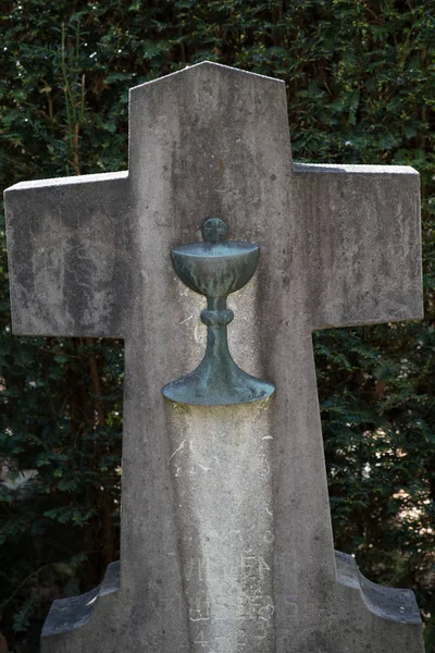 the holy grail on a stone cross