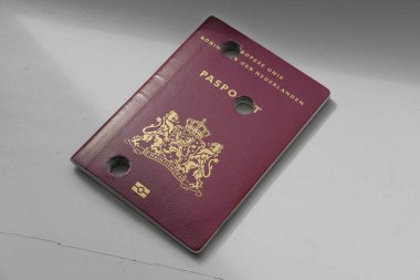 Dutch perforated passport on a plain background clipart
