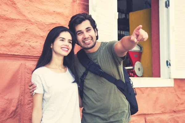 Tourist couple on sightseeing in a historical latin american city outdoor in summer in vintage retro look