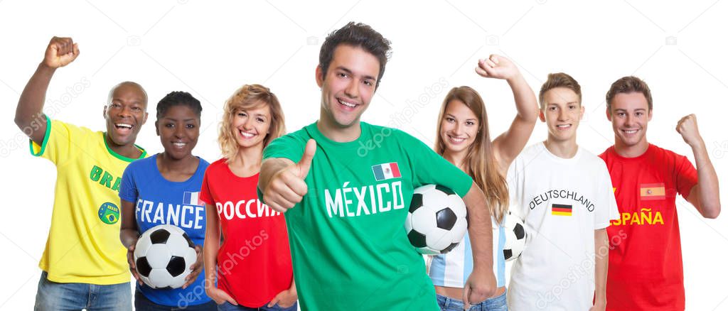 Optimistic mexican soccer supporter with ball and fans from other countries on isolated white background for cut out
