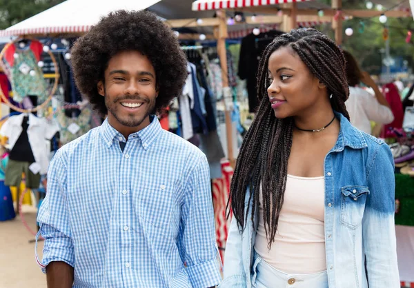 African american woman with husband at market outdoors in summer in city