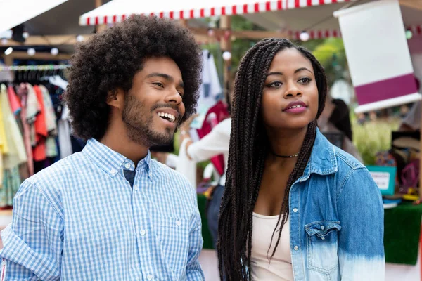 African american man with wife at market outdoors in summer in city