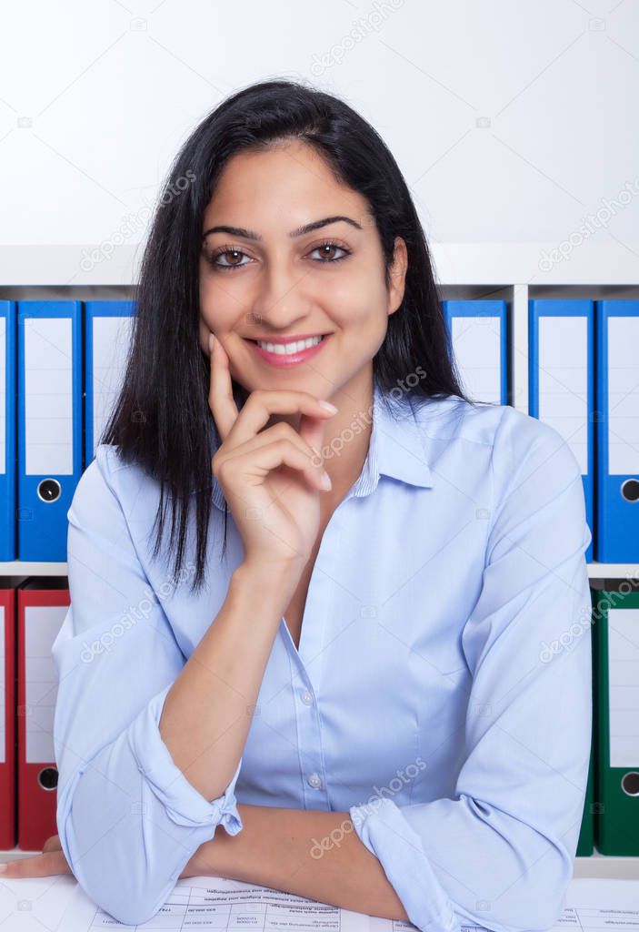 Happy turkish businesswoman looking at camera at office