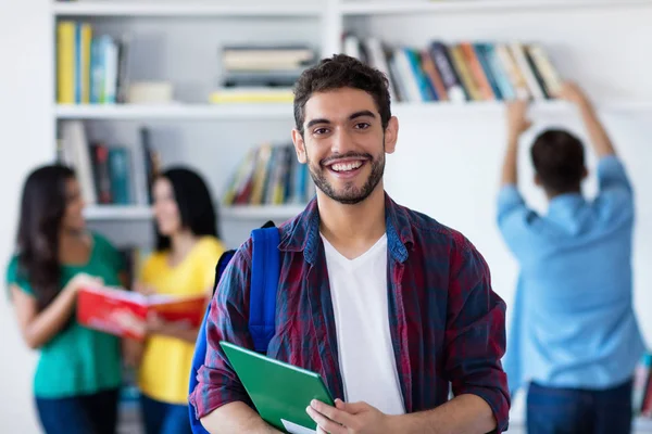 在大学图书馆与一群学生一起笑西班牙男生 — 图库照片