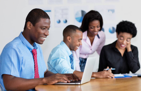 African american businessman working with computer at office of new business company