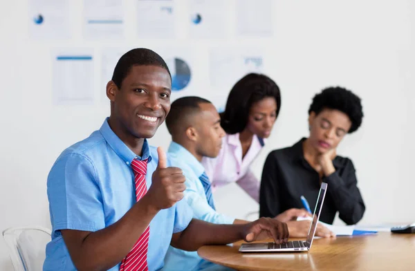 Smart african american businessman with business team at office of company