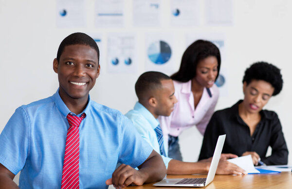 African american businessman with business team at office of company