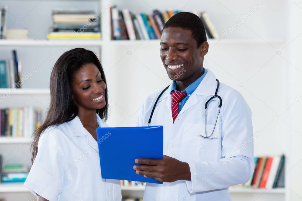 Laughing african american male and female doctor