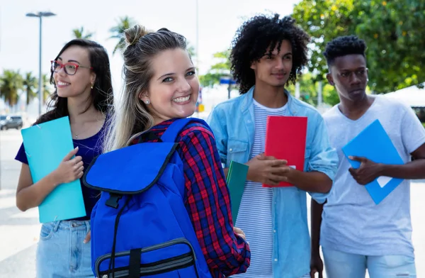 Lachen Noord-Europese vrouwelijke student met een groep vrienden — Stockfoto