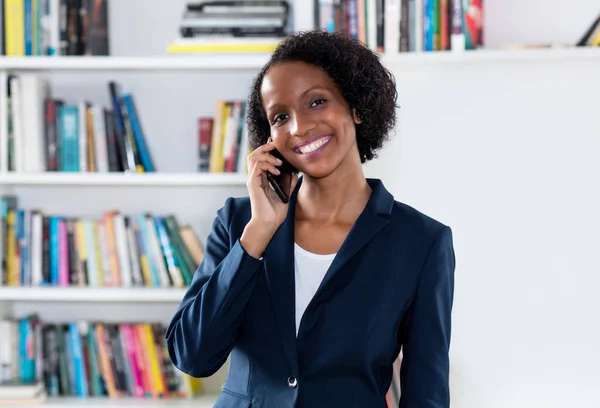 Laughing african american businesswoman talking with client at p