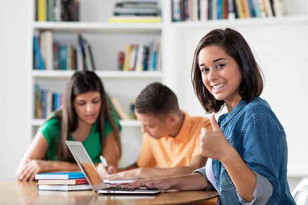 Successful spanish female student with group of learning student — Stock Photo, Image