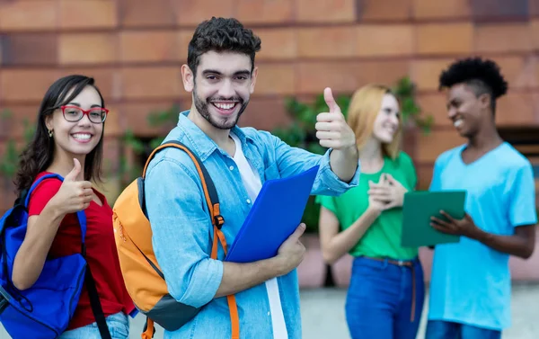 Cheering hispanic male and caucasian female student — Stock Photo, Image