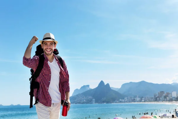 Laughing american hipster tourist at Ipanema beach at Rio de Jan