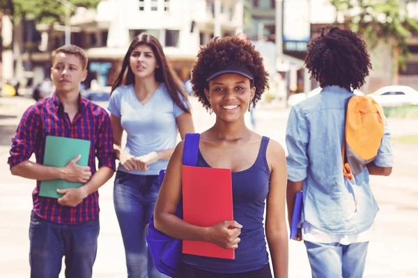 Hermosa mujer adulta joven afroamericana con estudiantes en ci —  Fotos de Stock