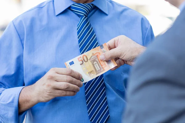 Businessman taking money as symbol for corruption — Stock Photo, Image