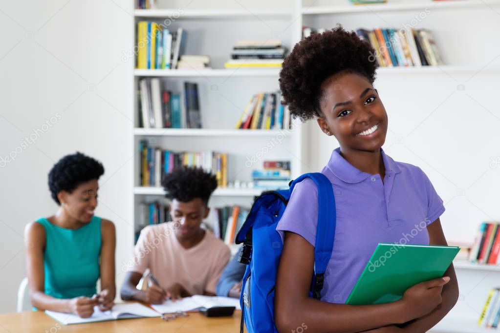 African american female young adult with students and teacher