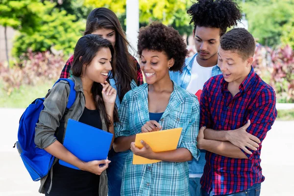 African american female student learning with group of latin and — Stock Photo, Image
