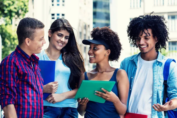 Group of multi ethnic students talking about classes — Stock Photo, Image