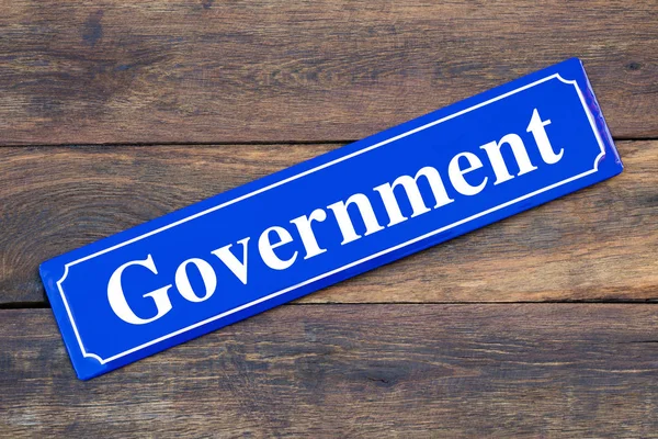 Government street sign on wooden background — Stock Photo, Image