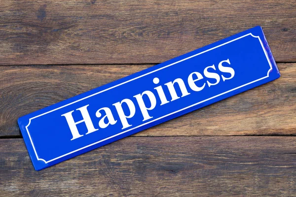 Happiness street sign on wooden background — Stock Photo, Image