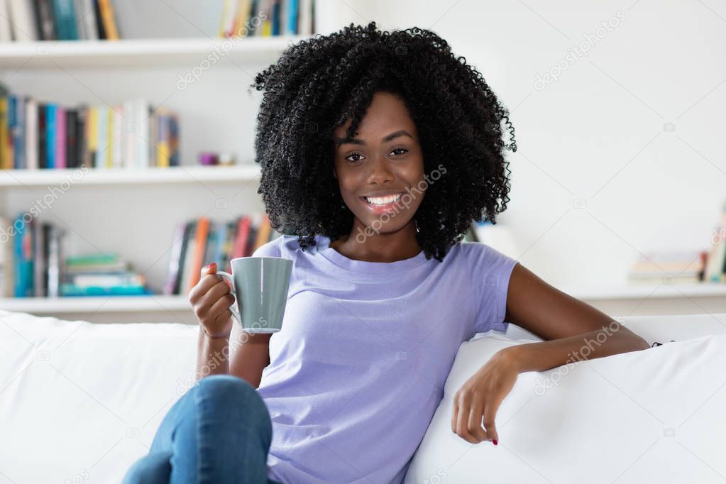 African american woman relaxing with cup of coffee