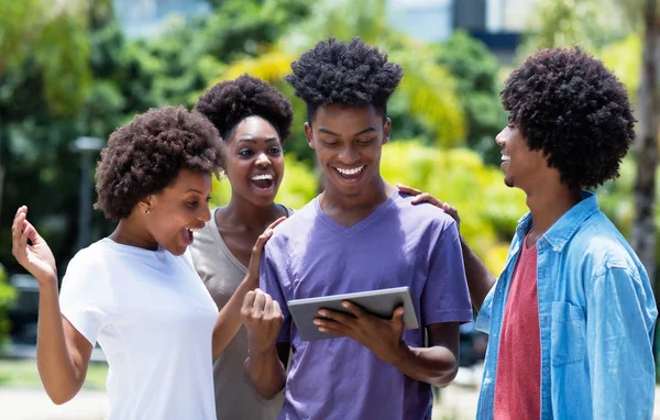 Laughing group of african american university students with digi — Stock Photo, Image