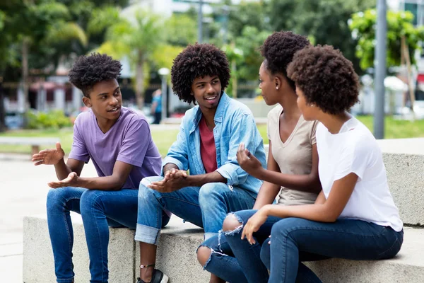 Group of african american young adults in discussion — Stock Photo, Image
