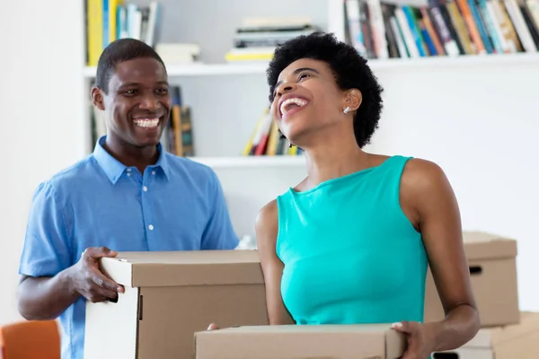 Laughing african american couple moving to new house — Stock Photo, Image
