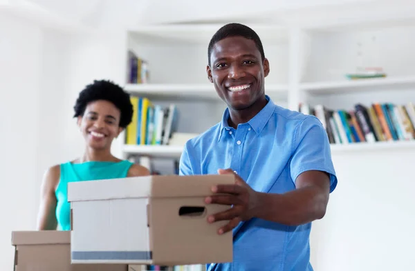 African american couple with boxes at new home — Stock Photo, Image