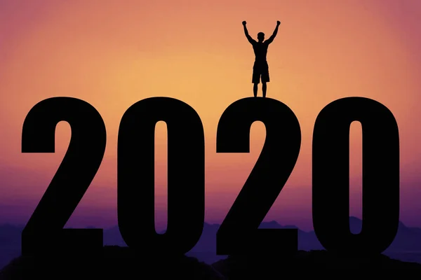 Puesta de sol con el nuevo año 2020 y silueta del hombre animador —  Fotos de Stock