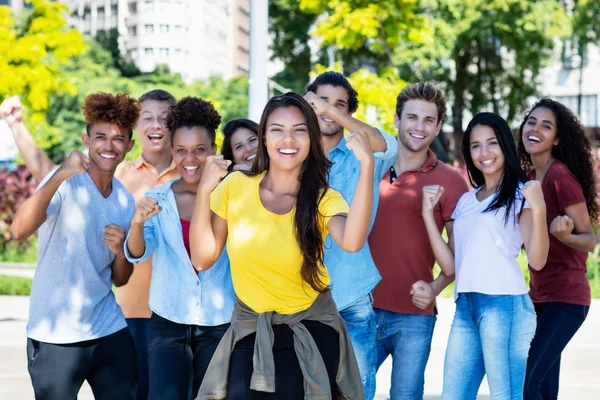 Large group of successful cheering students and young adults — Stock Photo, Image