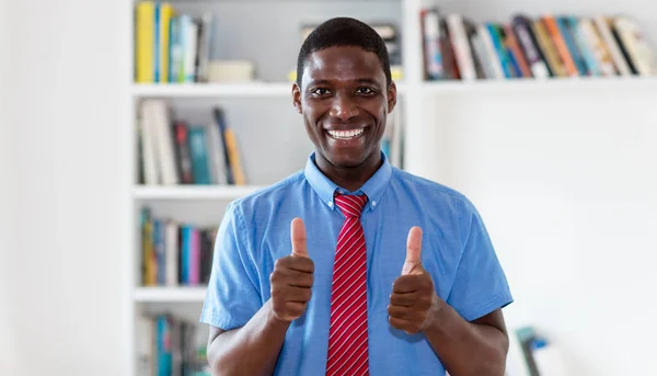 Мотивированный африканский американский бизнесмен, показывающий большие пальцы вверх — стоковое фото
