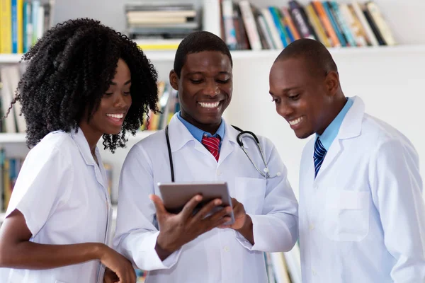 Team of african american doctors talking about patient