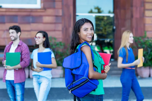 Beautiful mexican female student with group of young adults — Stock Photo, Image