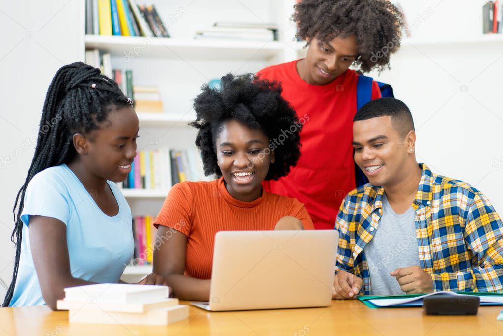 Group of african american and latin students working and learning at computer at classroom of university