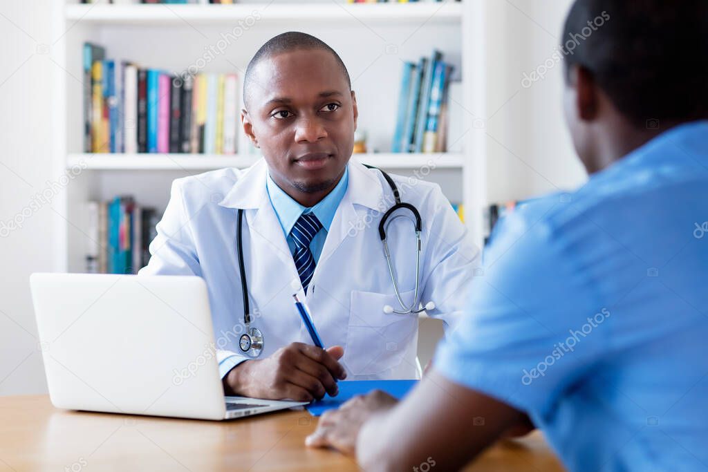 African american male doctor listening to infected patient at hospital